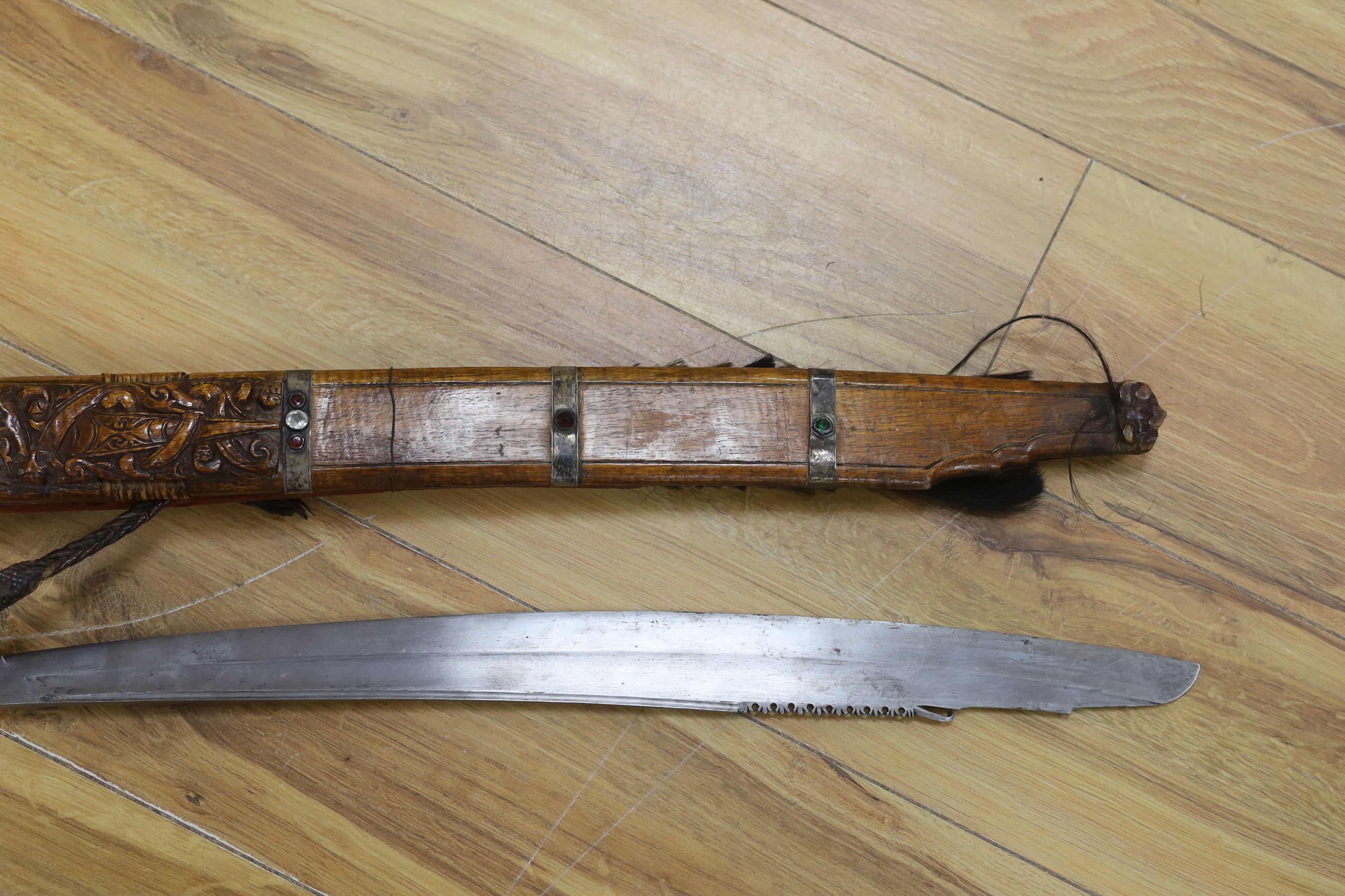 A Borneo 'headhunter's sword', a bone carving and feather swot (3), sword 77 cm long